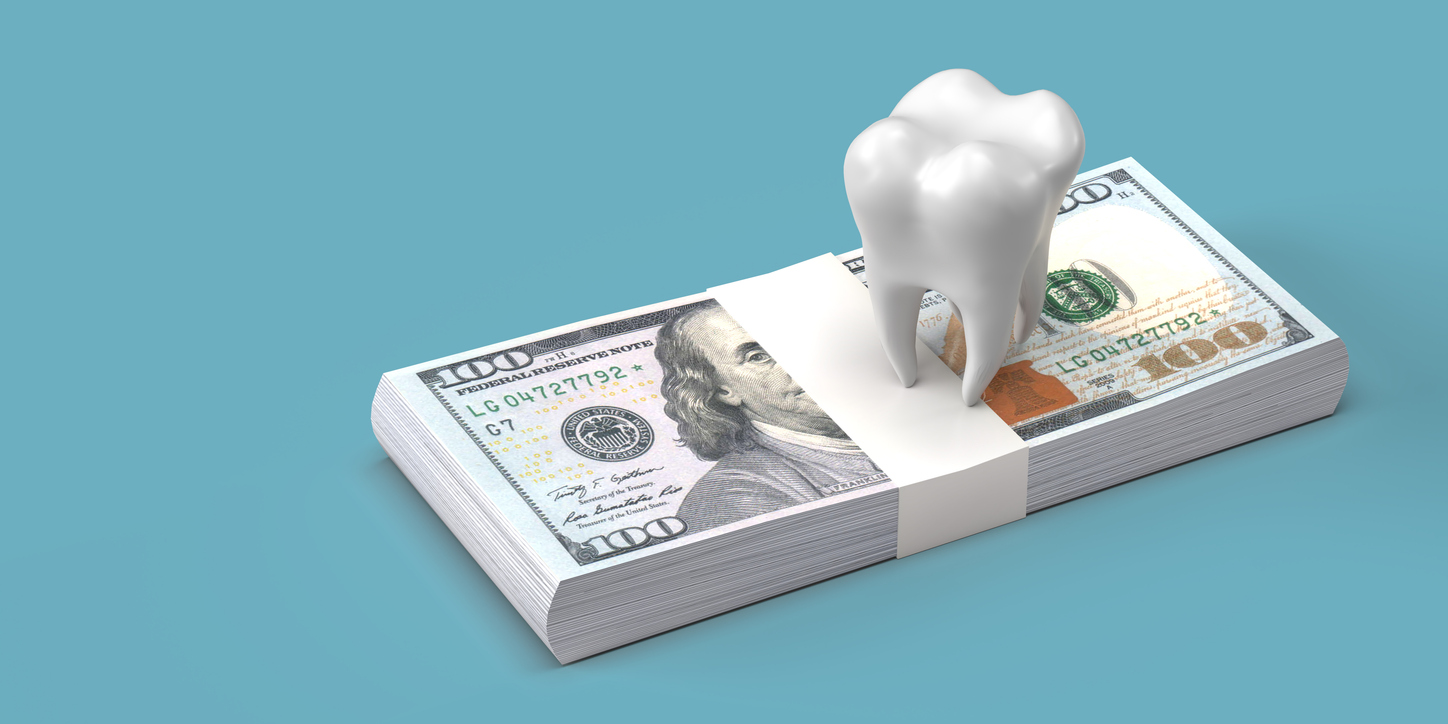 Ceramic model of tooth and stack of dollar banknotes on blue background with clipping path and large copy space. Cost of dental health concept of teeth whitening, examination and hygiene. 3D model illustration design.